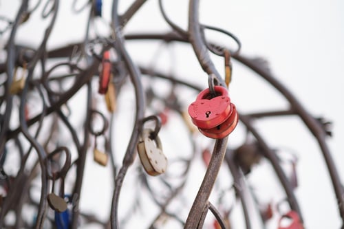 Preview: close up old rusty locks heart shaped on wire rope. Love lock on the bridge. tradition of hanging a