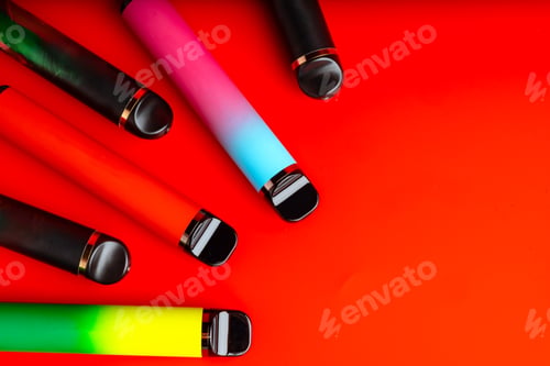 Preview: Colorful disposable electronic cigarettes on red background
