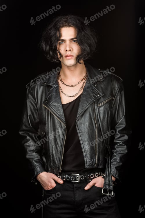 Preview: handsome man standing with hands in pockets isolated on black