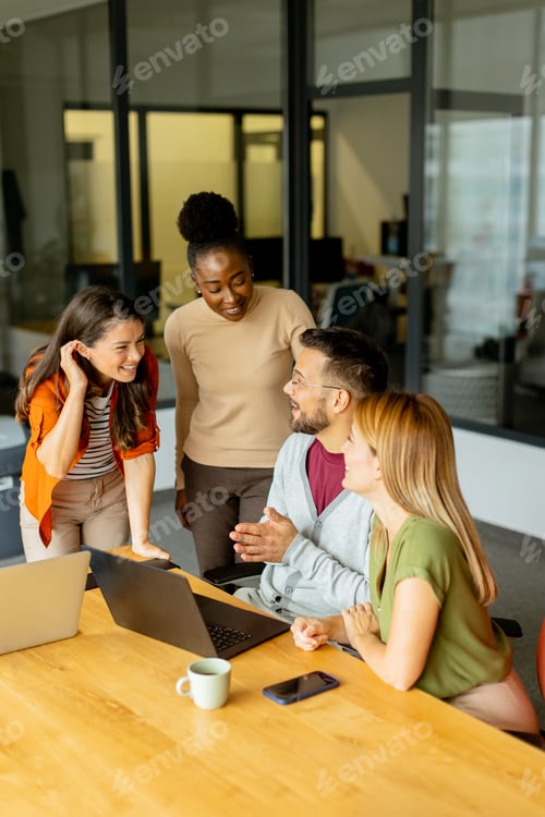 Preview: Young multiethnic startup team working in the modern office