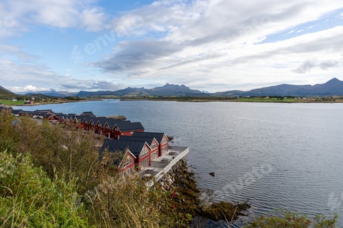 Preview: Several red houses line the shore by the water, Lofoten, Norway
