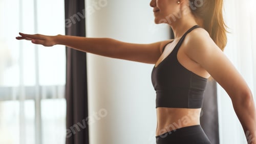 Preview: Closeup image of a fitness woman stretching arms while warming up before workout at home