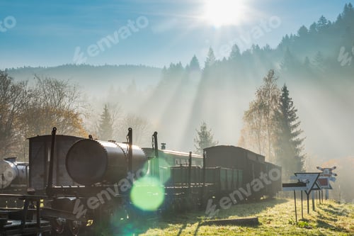 Preview: Sun rays and flare at misty morning in abandoned railway station