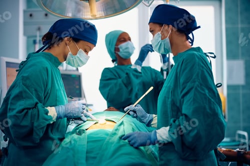 Preview: Female surgeon and her medical team operating a patient in the hospital.