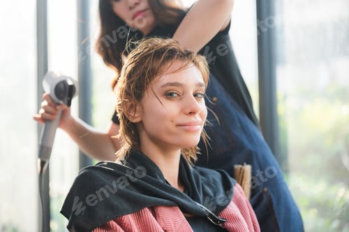 Preview: woman client person having a process to making treatment a hair with hairdresser in beauty salon