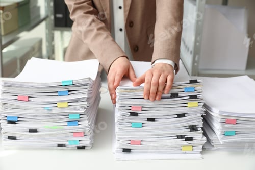 Preview: Woman working with documents at table in office, closeup