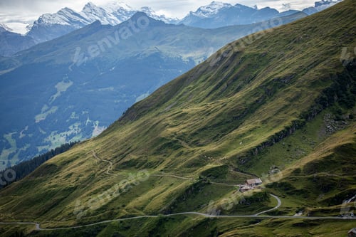 Preview: Aerial view of a green slope with majestic mountains. Grindelwald-First, Switzerland