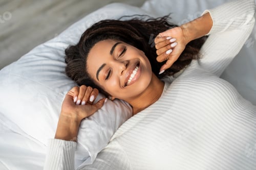 Preview: Happy African American female stretching after waking up