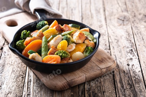 Preview: Stir fry chicken with vegetables on iron pan