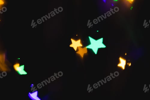 Preview: Multicoloured star bokeh lights with copy space on dark background