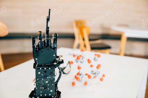 Preview: Futuristic concept with a black real robot hand making contact on a table. Symbolizing artificial