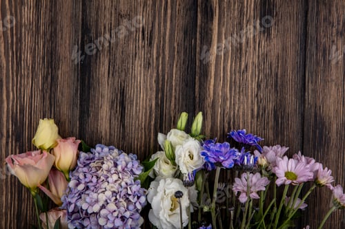 Preview: top view of flowers on wooden background with copy space