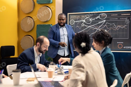Preview: Project team examining annual data reports on interactive board