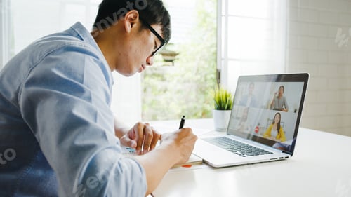 Preview: Young Asia businessman using laptop talk to colleagues about plan in video call meeting