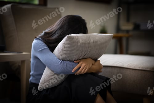 Preview: Unhappy lonely depressed Upset woman at home, she is sitting on the couch at home, feeling despair a