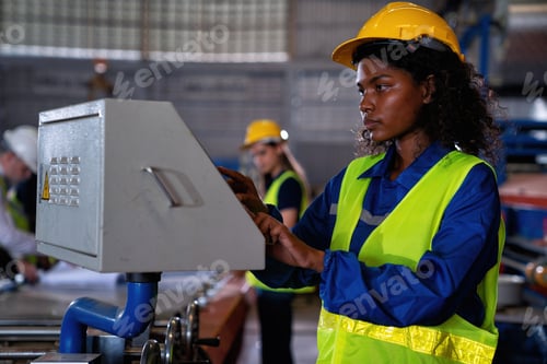 Preview: Female engineering operator wearing uniform Quality control maintenance,checking process in factory