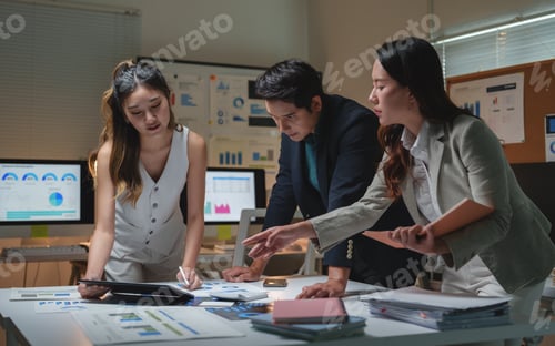 Preview: Professionals analyzing financial data late in modern office