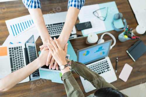Preview: Executives Stacking Hands In Meeting At Office