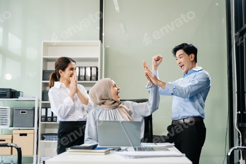 Preview: Happy businesspeople while collaborating on a new project in an office.
