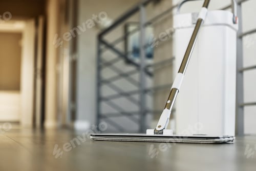 Preview: Cleaning supplies: mop and bucket with wringer on wooden laminate floor