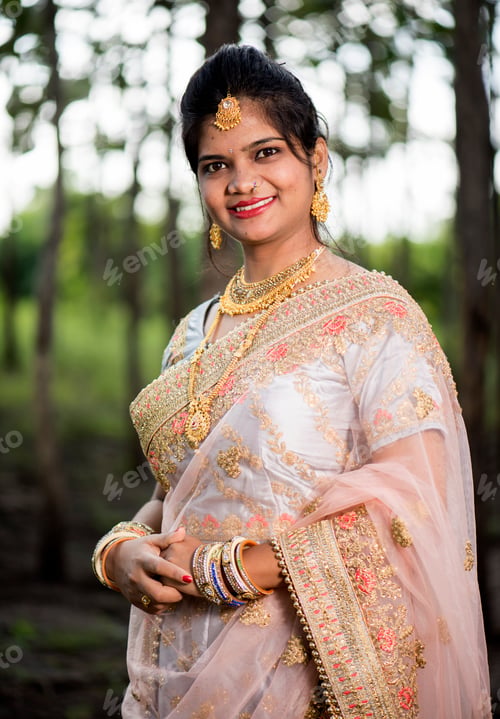 Preview: Portrait of beautiful bride wearing traditional clothing outside in nature.