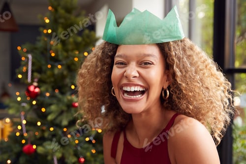 Preview: Portrait Of Smiling Woman Wearing Paper Hat Standing By Tree At Home