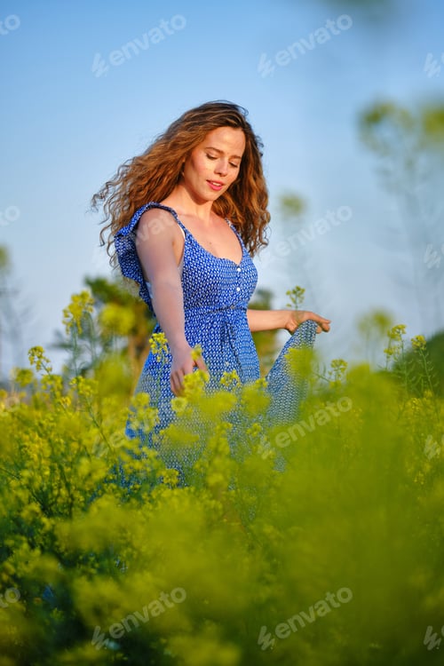 Preview: Content woman walking on grassy meadow in summer countryside