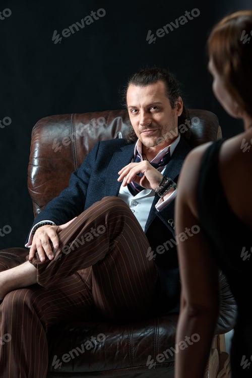 Preview: The Artist Or Mature Man Wearing Suit In A Classical Retro Fashion Style. The Woman Standing Near