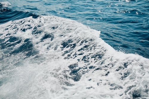 Preview: Close up of foamy ocean waves with glistening sunlight reflections