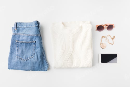 Preview: flat lay with knitted sweater, trendy jeans, accessories and smartphone, isolated on white