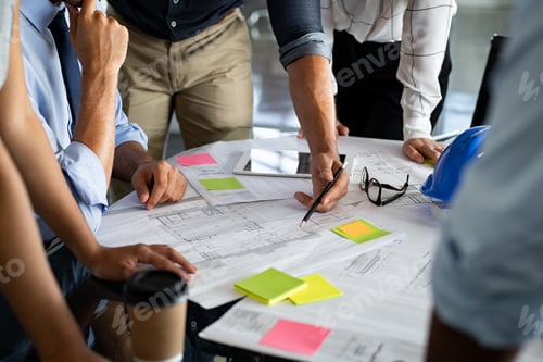 Preview: Architects discussing project on blueprint