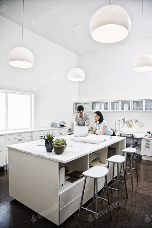 Preview: HIspanic man and woman working together in an architect's office.