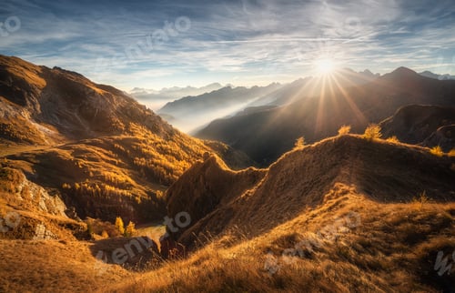 Preview: Mountains in low clouds at beautiful sunset in autumn in Italy