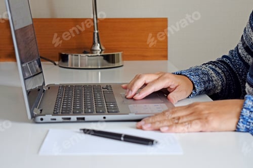 Preview: Typing on Laptop Keyboard at Clean White Desk