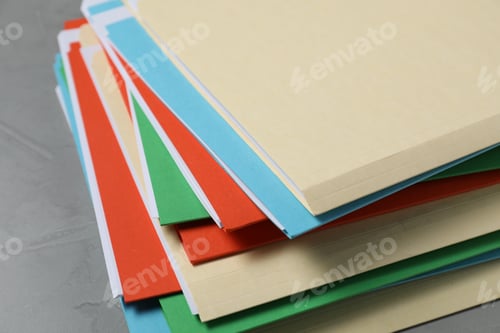 Preview: Many documents in folders on grey table, closeup