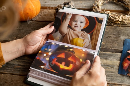 Preview: Halloween printed photos in picture album. Person browsing photo album.