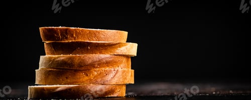 Preview: Sliced wheat bread. On a black background.