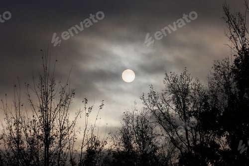 Preview: Morning Sun Through Clouds - Photograph Of An Eerie And Dramatic Morning Sun Low On The Horizon And