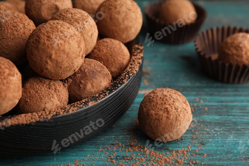 Preview: Plate of chocolate truffles on wooden background, closeup