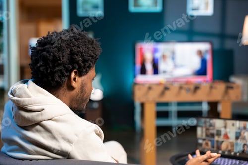 Preview: Manager teleworking in living room, presenting project brief to workers