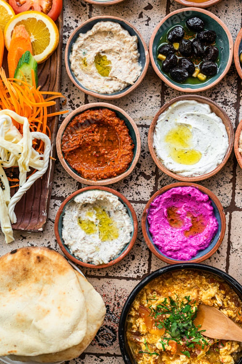 Preview: Turkish Village Breakfast on the ceramic table with pastries, vegetables, greens, spreads, cheeses