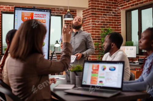 Preview: Bearded man answers questions in meeting