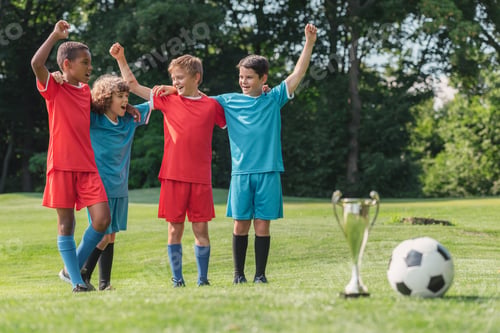Preview: selective focus of multicultural kids gesturing near trophy and football