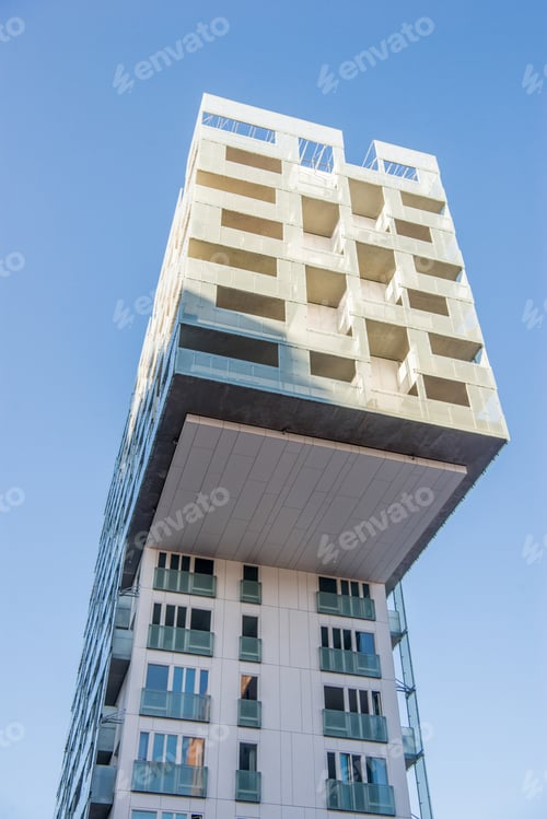 Preview: low angle view of beautiful modern building against blue sky at Barcode district, Oslo