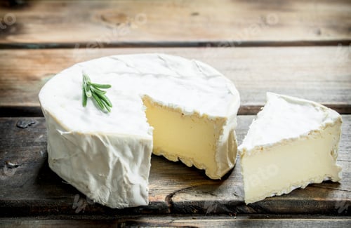 Preview: Brie cheese with a sprig of rosemary.
