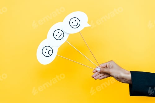 Preview: KYIV, UKRAINE - AUGUST 5, 2019: cropped view of woman holding set with emoticons on speech bubbles