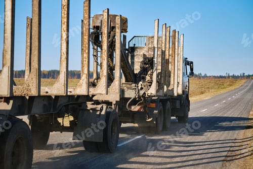 Preview: Empty logging truck with trailer on countryside road