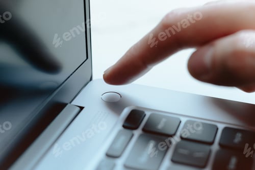 Preview: Man touching Laptop fingerprint reader. Scan finger to log into account. Access