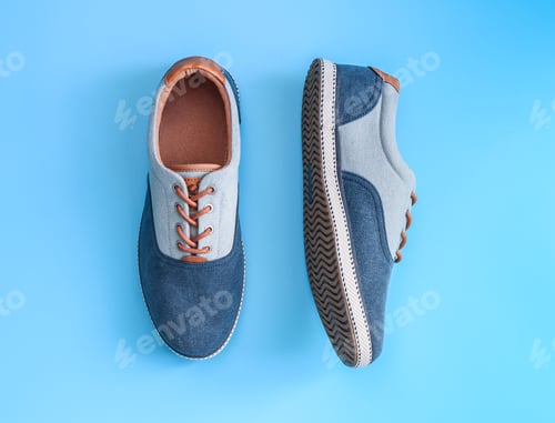 Vista previa: Denim male sneakers on a blue background.
