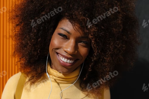 Preview: Black woman listening to music in the street
